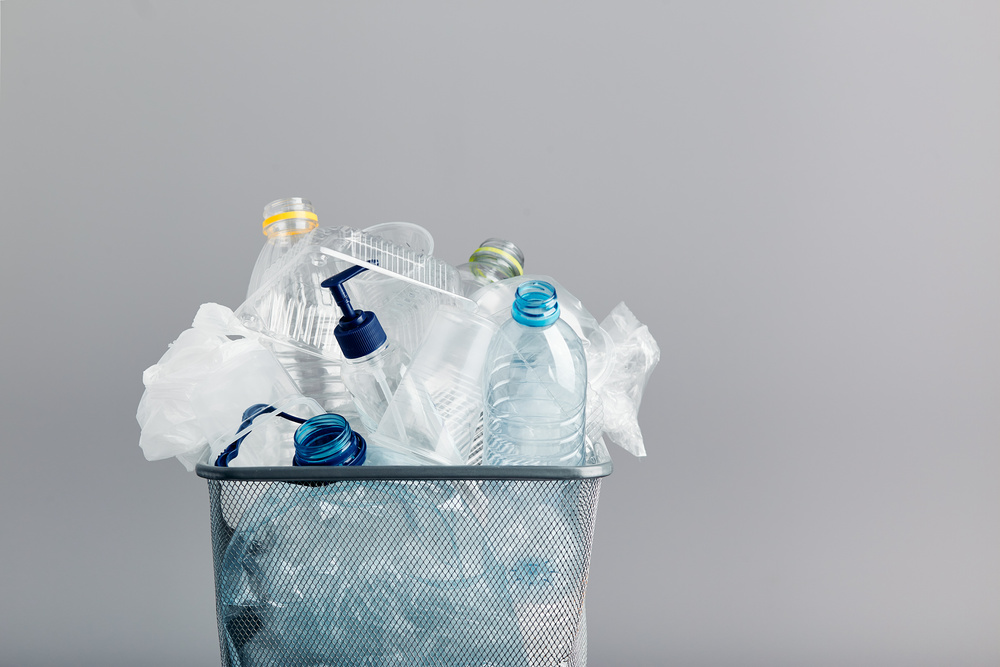 Reducing Plastic Demand vs Recycling - bin full of consumer plastics